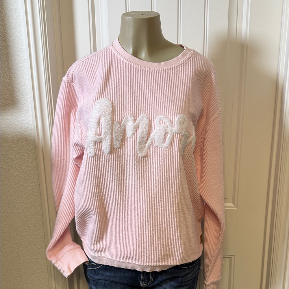 Chic Pink Ribbed Women's Sweater with AMORE written across the front in white